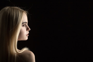 beautiful girl profile portrait on black background