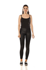 Fototapeta premium Whole figure of a young woman in tights and blouse