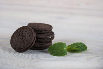 Fototapeta premium Chocolate biscuits on a light wooden background. Wafers with chocolate