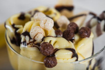 Roll of banana ice cream. Fresh fried fruit ice cream, ice roll on a light wooden background