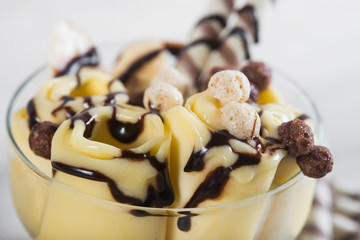 Roll of banana ice cream. Fresh fried fruit ice cream, ice roll on a light wooden background