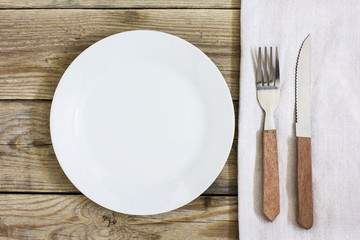 Empty Plate And Cutlery On The Wooden Table./Empty Plate And Cutlery On The Wooden Table 