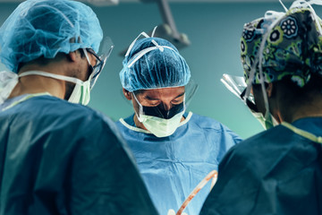 Team of Surgeons Operating.