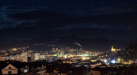 Fototapeta premium Industrial city in night with sky full of stars