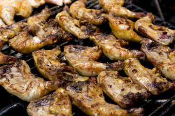 Chicken Quarters Cooking on a Grill