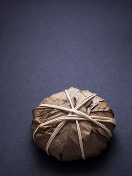 French banon cheese wrapped in chestnut leaves isolated on black background
