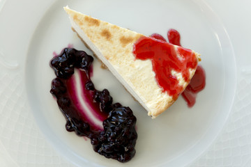 Overhead Close Up of Slice of Cheesecake with Blueberry Jam