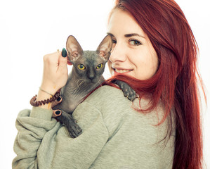 young woman portrait with grey sphinx cat on white background