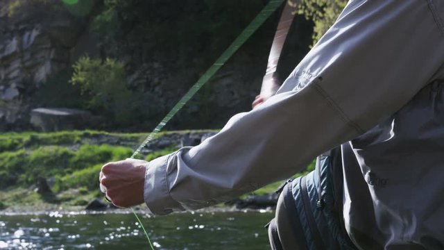 close up of hand casting while fishing