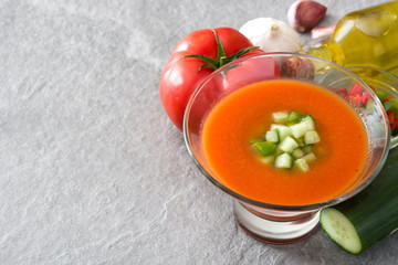 Traditional Spanish cold gazpacho soup on gray stone.
