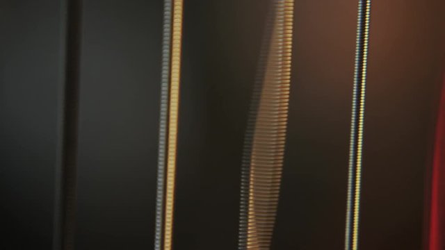 macro of strings vibrating while being played