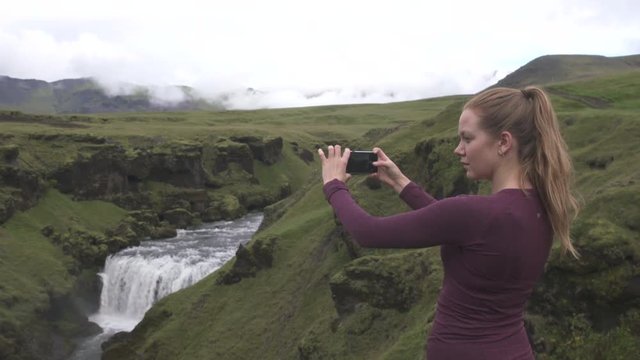 woman taking photos of Icelandic landscape
