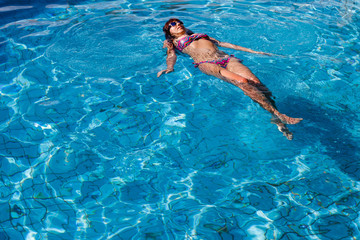 Woman resting in outdoor pool