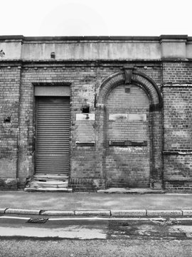 abandoned building  with shutter and bricked up doorway