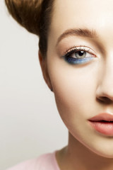 Fototapeta premium Portrait of beautiful woman with blue make up on eyes and blue glitter in hair. Beauty concept.
