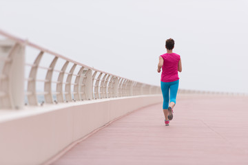 woman busy running on the promenade