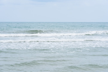 Ocean waves exhausted on the beach.