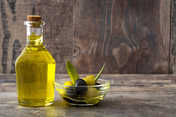 Virgin olive oil in a crystal bottle on wooden table

