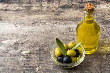 Virgin olive oil in a crystal bottle on wooden table
