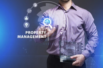 Business, Technology, Internet and network concept. Young businessman working on a virtual screen of the future and sees the inscription: Property management