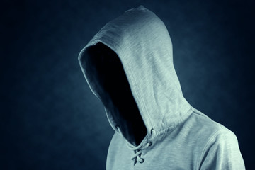 Faceless unknown and unrecognizable person without identity wearing  hooded jacket.