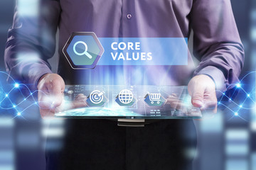 Business, Technology, Internet and network concept. Young businessman working on a virtual screen of the future and sees the inscription: Core values