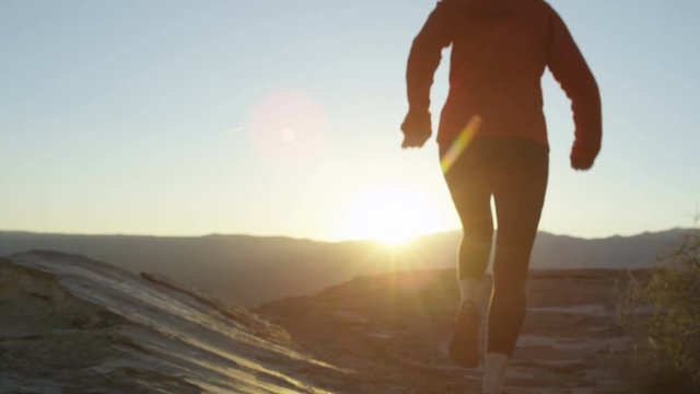 woman running towards sunset 