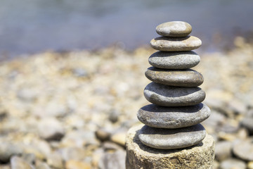 Round stone pile over blurred stone beach background