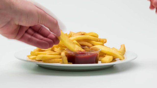 Time-lapse eating of french fries with ketchup.