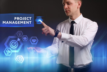Business, Technology, Internet and network concept. Young businessman working on a virtual screen of the future and sees the inscription: Project management