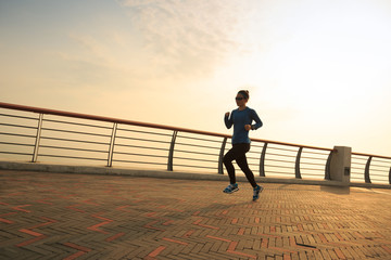 healthy lifestyle woman runner running at seaside