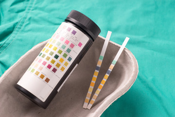 Urine test strips lying in a one use capsule
