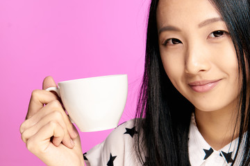 lady with a white cup, drink, light shirt