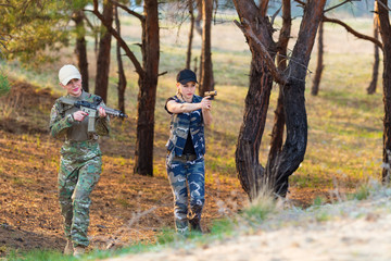 Beautiful women rangers with weapon in camouflage