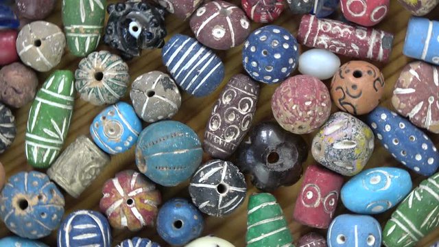 Rotating ancient vintage colorful decorated ceramic indian beads from Varanasi, video background