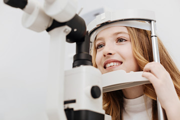 Cheerful pretty child getting her eyesight tested