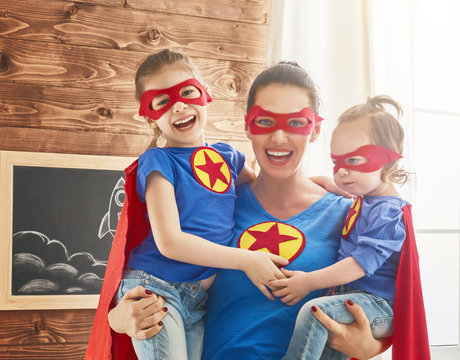 Girls and mom in Superhero costumes