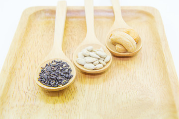 sunflower kernels and black sesame and cashew nuts on spoon