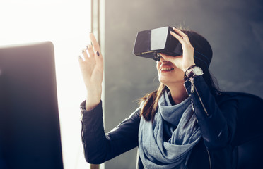 Woman using virtual reality 3-D glasses headset