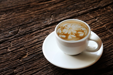 Cup of coffee latte on the old wood table vintage.