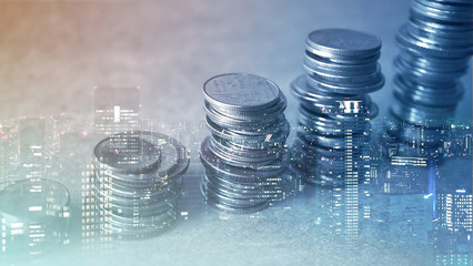 Double exposure of city and rows of coins for finance and banking concept

