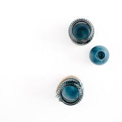 Three blue stylish jars on white background. Top view minimal decoration concept.