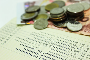 Book Bank and Out of Focus of Thai Coins and Thai Banknote