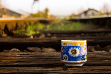 Dirty mug in the middle of a railway