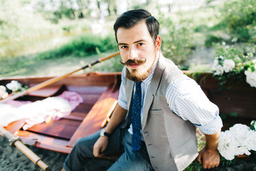 Handsome groom on the boat