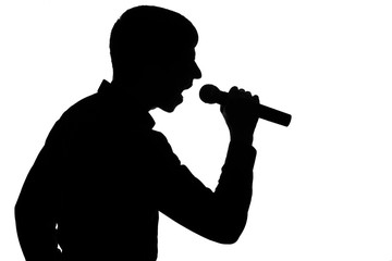 Fototapeta premium Silhouette of a man screaming into a microphone