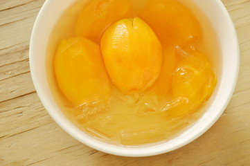 Marian plum tropical fruit in syrup with ice cold dessert on cup