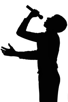 Silhouette of a man screaming into a microphone