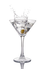 Splash in martini glass of white transparent alcoholic cocktail drink with olive