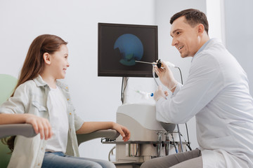 Fototapeta premium Smiling girl being ready for health examination
